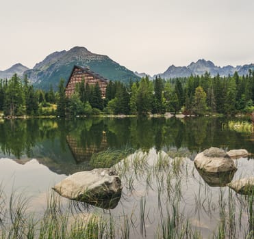 Strbske Pleso Mountain Lake in High Tatras Mountains, Slovakia with Rocks and Grass in Foreground