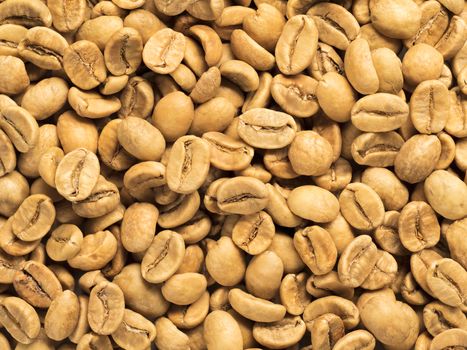 White coffee beans as background. Top view or flat lay. Closeup. Image with natural colors