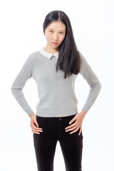 Chinese teenager standing with hands on hips, looking serious