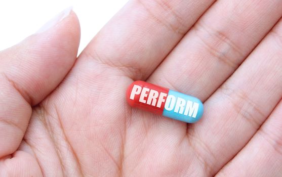 Close up of a hand holding a performance pill