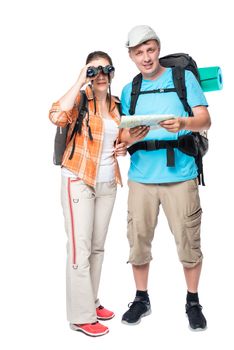Girl with binoculars and a man with the map two travelers on a white background with backpacks