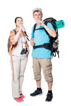 a pair of active tourists with bottles of water traveling with backpacks on a white background