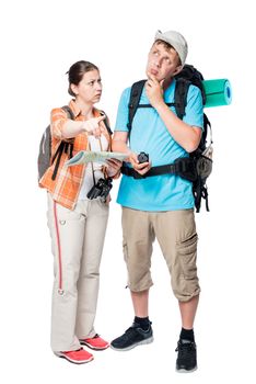 more lost perplexed tourists with backpacks and map on a white background