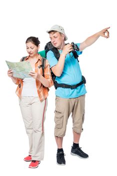 Vertical portrait of full-length two travelers with a map on a white background