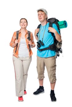vertical portrait in full length of happy tourists with backpacks on a white background