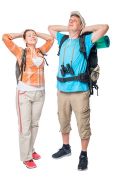 relaxing couple of tourists with backpacks on a white background