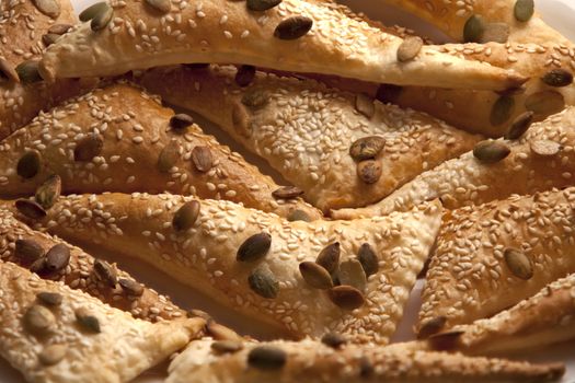 flaky Triangles  puff pastry Sprinkle Seeds pumpkin, sesame seeds, background