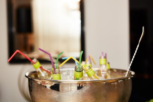 bottles with tasty drink in ice. Shallow dof.