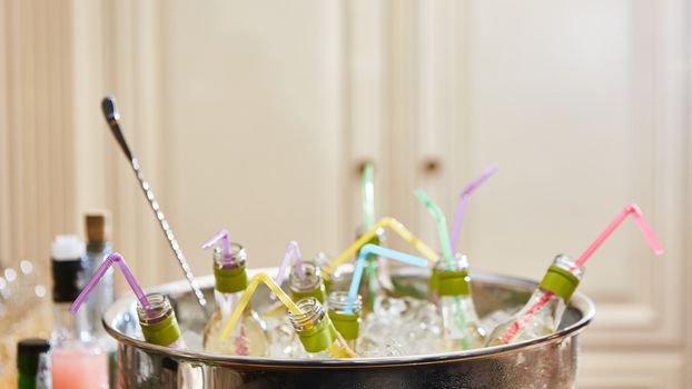 bottles with tasty drink in ice. Shallow dof.