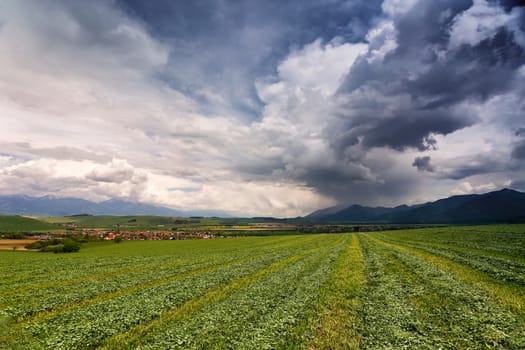 Spring rain and storm in mountains. Green spring hills of Slovakia. Spring stormy scene