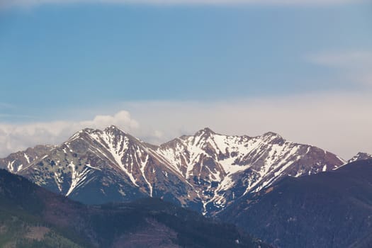 Snow melting on the mountains peak. Spring in Slovakia, Tatras mountains.