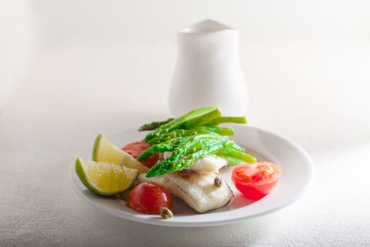 Mackerel fillets with asparagus lemon and tomato