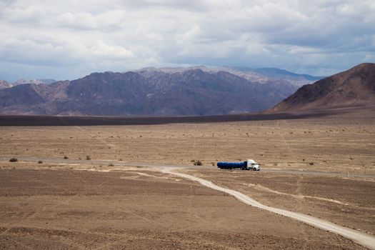 Truck driving through Nazca Desert Highway.