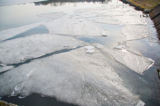 Spring ice on the lake and sun rays ,march