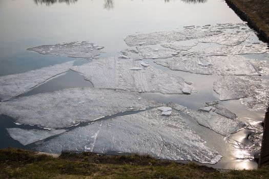 Spring ice on the lake and sun rays ,march