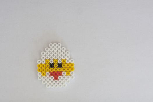 happy easter card with a beaded chicken on a white background