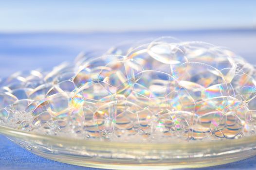 Macro soap bubbles on blue background