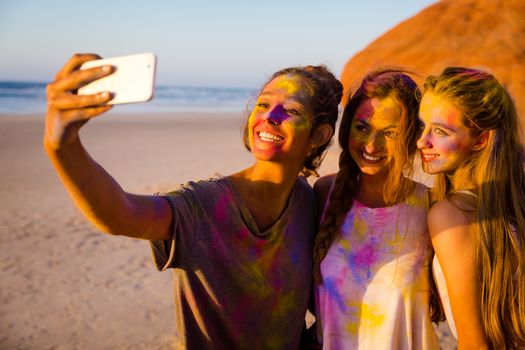 Teenagers making a selfie after playing with colored powder