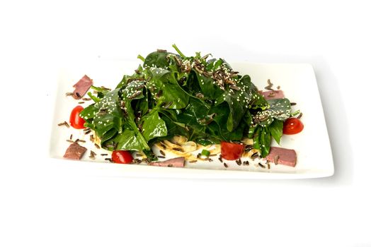 Arugula and spinach salad with tomato and cedar nuts