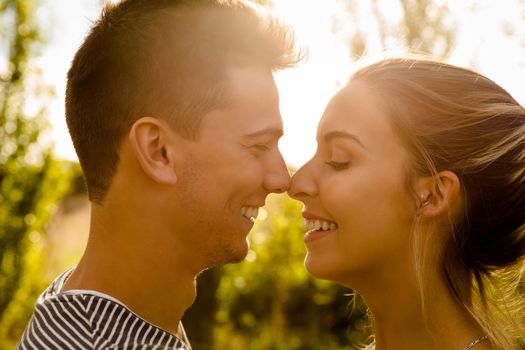 Portrait of a happy young couple in love and giving a kiss