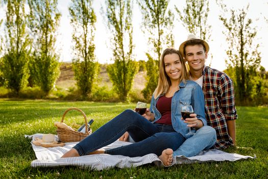 Shot of a beautiful couple on the park having fun together while making a picnic