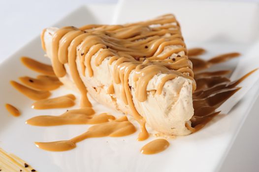Delicious frozen cheesecake with caramel and sweet condensed milk topping