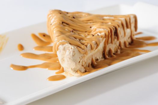 Delicious frozen cheesecake with caramel and sweet condensed milk topping