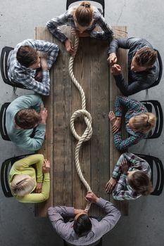 Hipster business teamwork brainstorming planning meeting concept, people sitting around the table with rope node