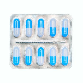 Blister pack of blue and white capsules isolated on white background.