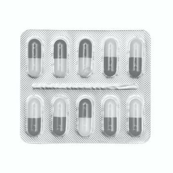 Blister pack of gray and white capsules isolated on white background.