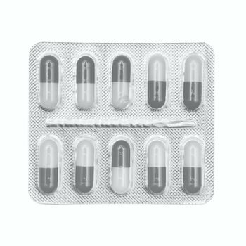 Blister pack of gray and white capsules isolated on white background.