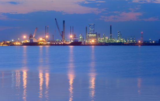 Industrial Petrochemical plant and sea in night time