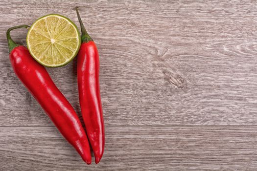 Red chilli and lime on a wooden background