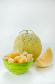 Ripe melon with slice on white background