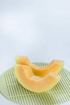 freshly cut cantaloupe melon on white background