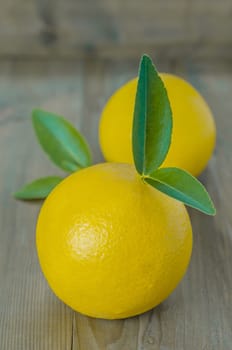 ripe orange with leaves on wooden background