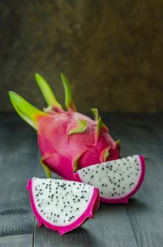 Ripe Dragon fruit or Pitaya with slice on wooden background , still life