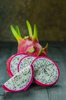 Ripe Dragon fruit or Pitaya with slice on wooden background , still life