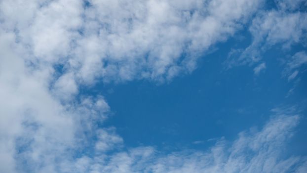 White fluffy clouds on a blue sky background