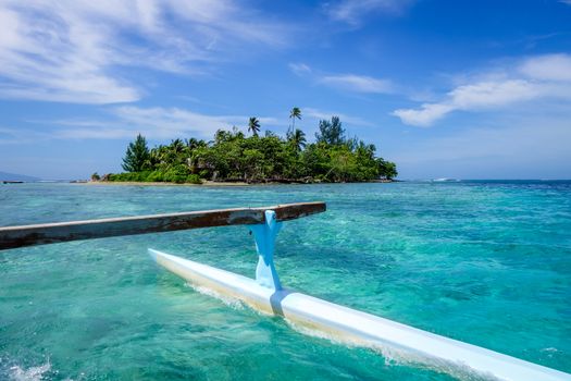 Pirogue on the way to paradise tropical atoll in Moorea Island lagoon. French Polynesia