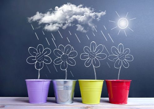 Chalkboard sketch of spring daisies inside flower pots with sun, clouds and rain weather 