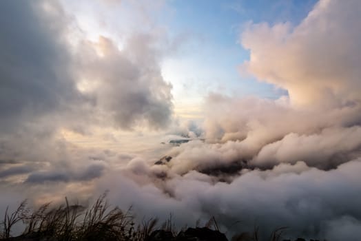 Beautiful nature sky scape cloud and fog in sunrise on peak mountains in winter at Phu Chi Fa Forest Park, Chiang Rai, Thailand