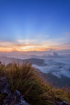 Beautiful landscape nature, sunrise on peak mountain with sun cloud fog and bright colors of sky in winter at Phu Chi Fa Forest Park is a famous tourist attraction of Chiang Rai Province, Thailand