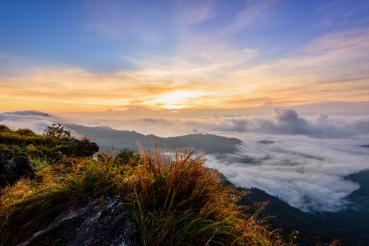 Beautiful landscape nature, sunrise on peak mountain with sun cloud fog and bright colors of sky in winter at Phu Chi Fa Forest Park is a famous tourist attraction of Chiang Rai Province, Thailand