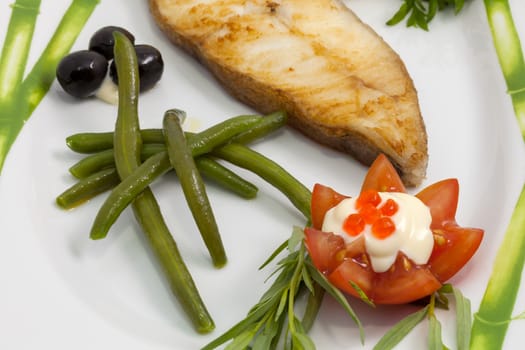 freshly cooked fish and fresh vegetables on the plate