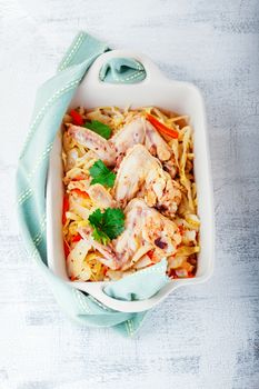 Braised cabbage with chicken on a white surface