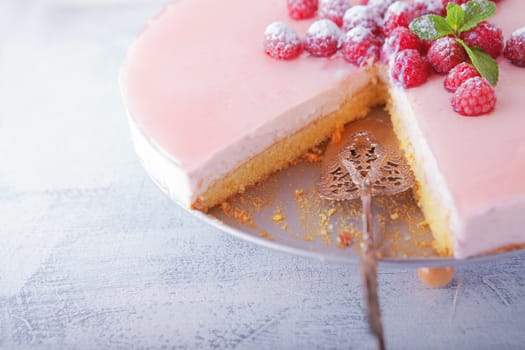 Raspberry yogurt cake with berries on a table