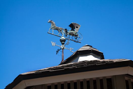 A Weather Vane which has a horse and carriage