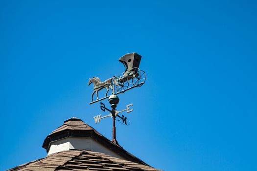 A Weather Vane which has a horse and carriage