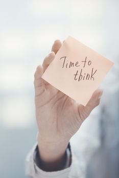Woman holding sticky note with Time to think text